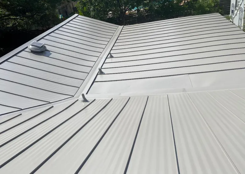 Solar attic fan installed on a metal roof for Roof Ventilation in Sturtevant
